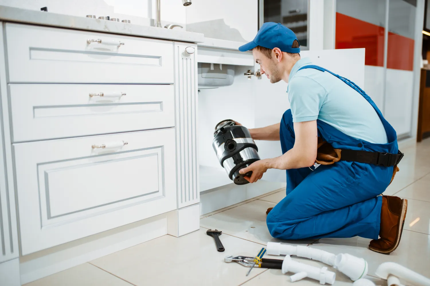 Plumber installing disposer